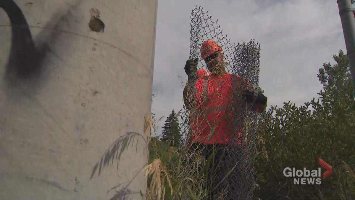 Crews fixing the fence restricting access to the train tracks in Mississauga on Jily 27, 2022.