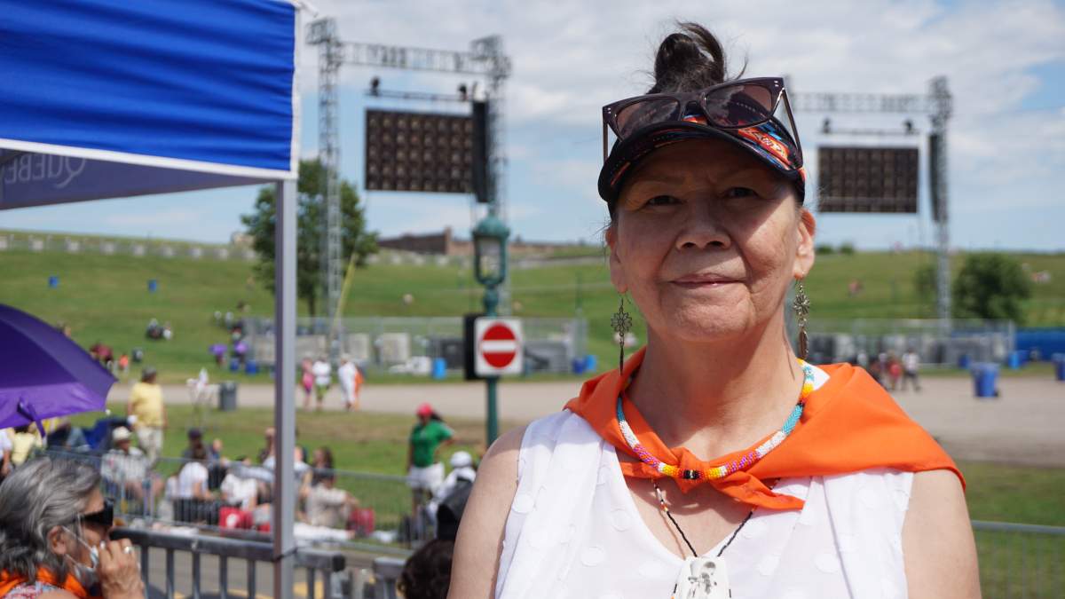 Lise Coocoo-Dubé of Atikamekw de Manawan waits to see Pope Francis pass through the Plains of Abraham in Quebec City on Wed. July 27, 2022.