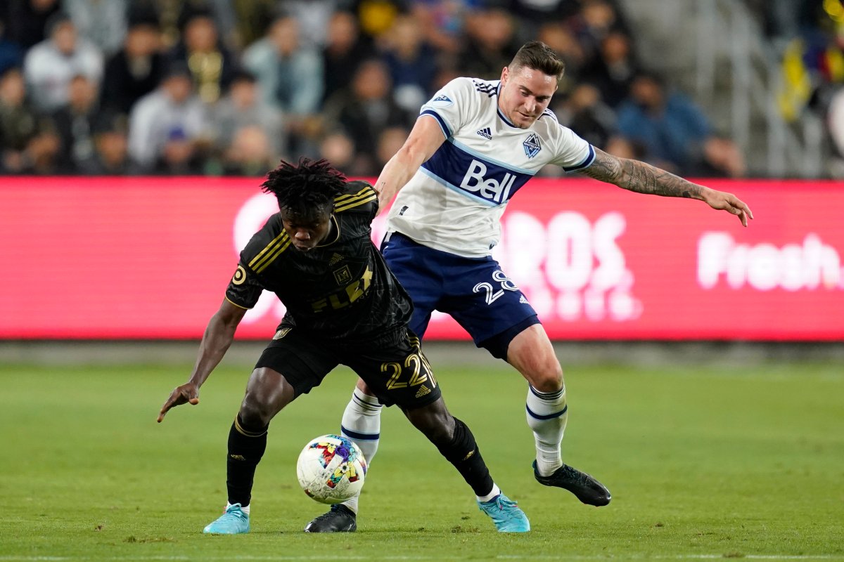 Los Angeles FC forward Kwadwo Opoku, front, and Vancouver Whitecaps defender Jake Nerwinski (28) battle for the ball during MLS action in Los Angeles, on Sunday, March 20, 2022. LAFC won 3-1.