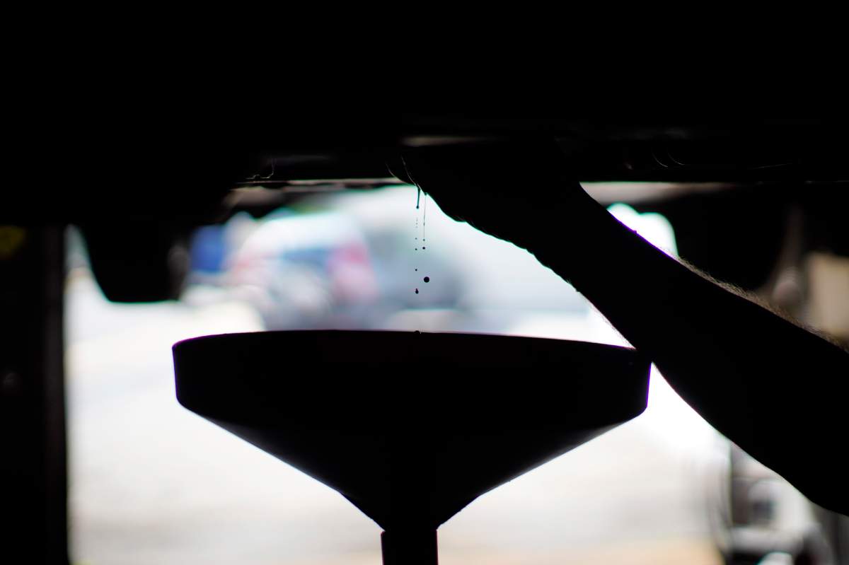 A mechanic drains oil from a car an auto repair shop. When it comes to recycling used oil, the B.C. Used Oil Management Association website has a map that shows local facilities that accept used oil and used antifreeze.