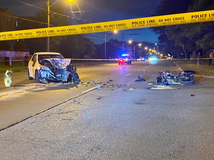 Police on the scene of a collision in Toronto involving a car and a motorcycle.