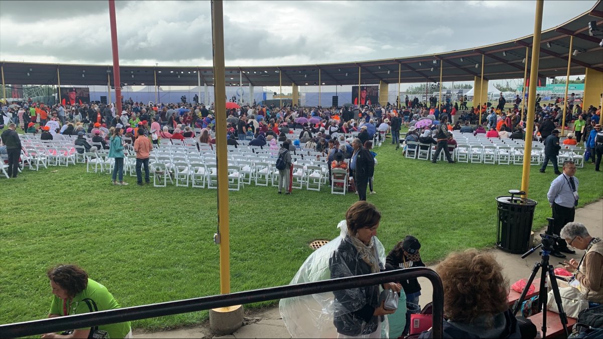 People arrive in Maskwacis, Alta., Monday, July 25, 2022 to hear from Pope Francis.