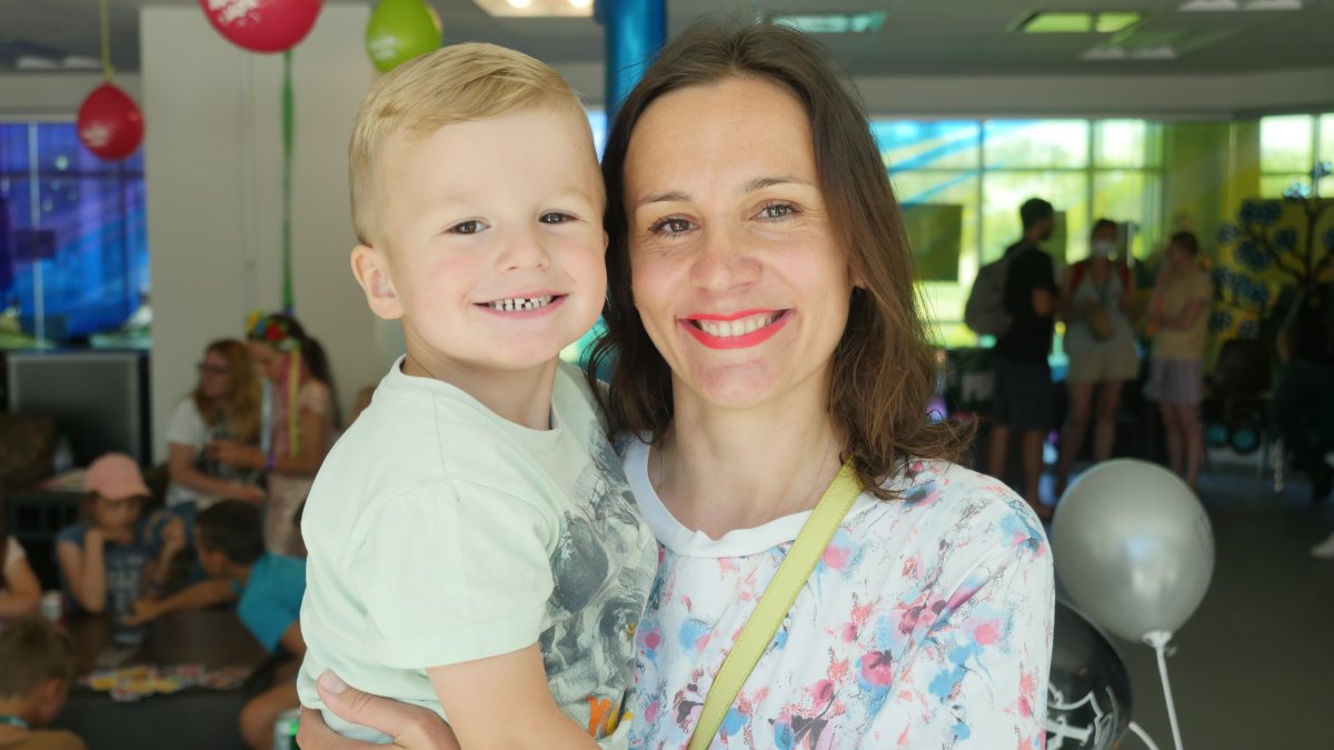 Olena Storozhenko holding her 3-year-old son