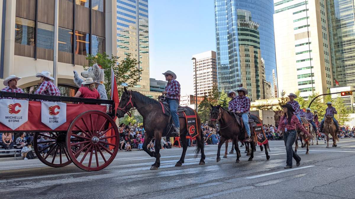 Calgary Flames defenceman Michael Stone along with members of the Calgary Roughnecks lacrosse team during the 2022 Calgary Stampede parade on July 8, 2022.