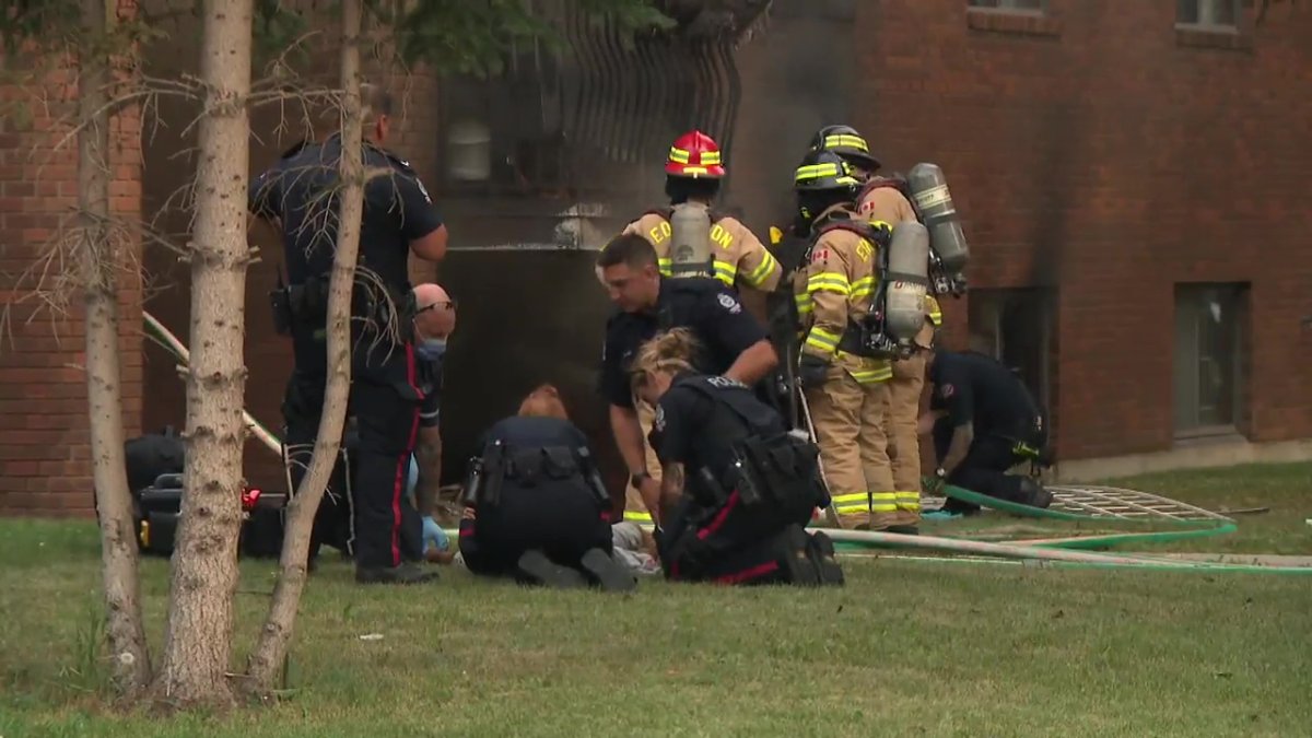 A person receiving medical attention after a fire at a central Edmonton apartment building near 117 Street and 108 Avenue on Friday, July 29, 2022.