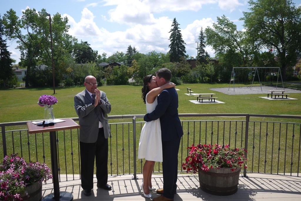 May Ellen Lim and Michael Quinlan share a kiss on their wedding day, July 1, 2015.