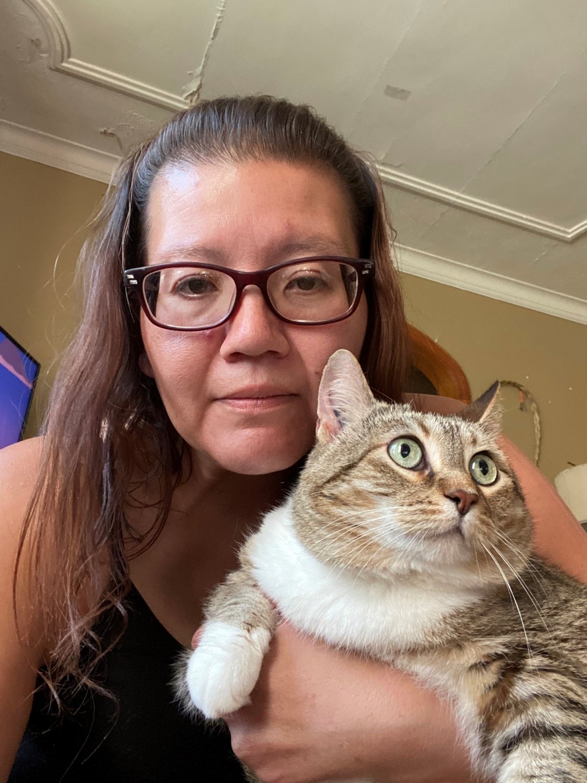 Winnipegger Michelle Bombay and her long-lost cat, Eva. Eva was returned to Bombay last month after running away from home nearly nine years ago.