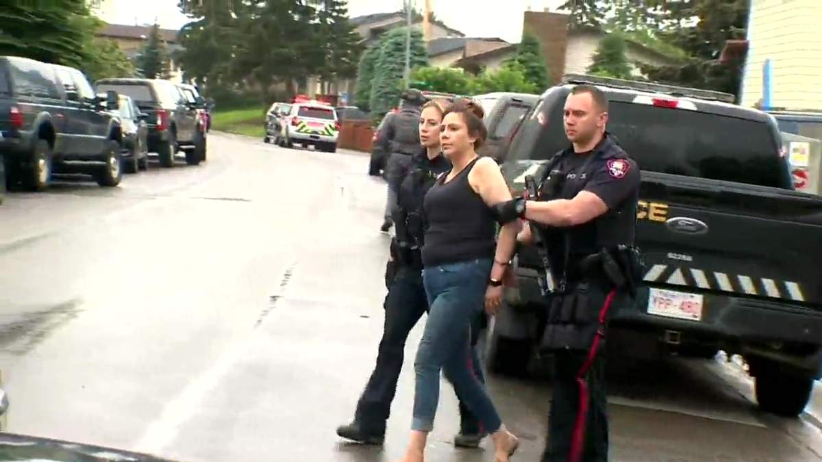 Calgary police take a woman into custody following a shooting in Falconridge on July 4, 2022.