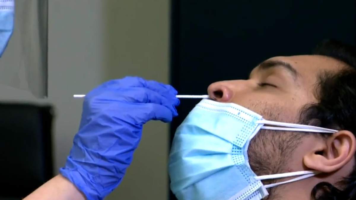 A man receives a COVID-19 rapid test.