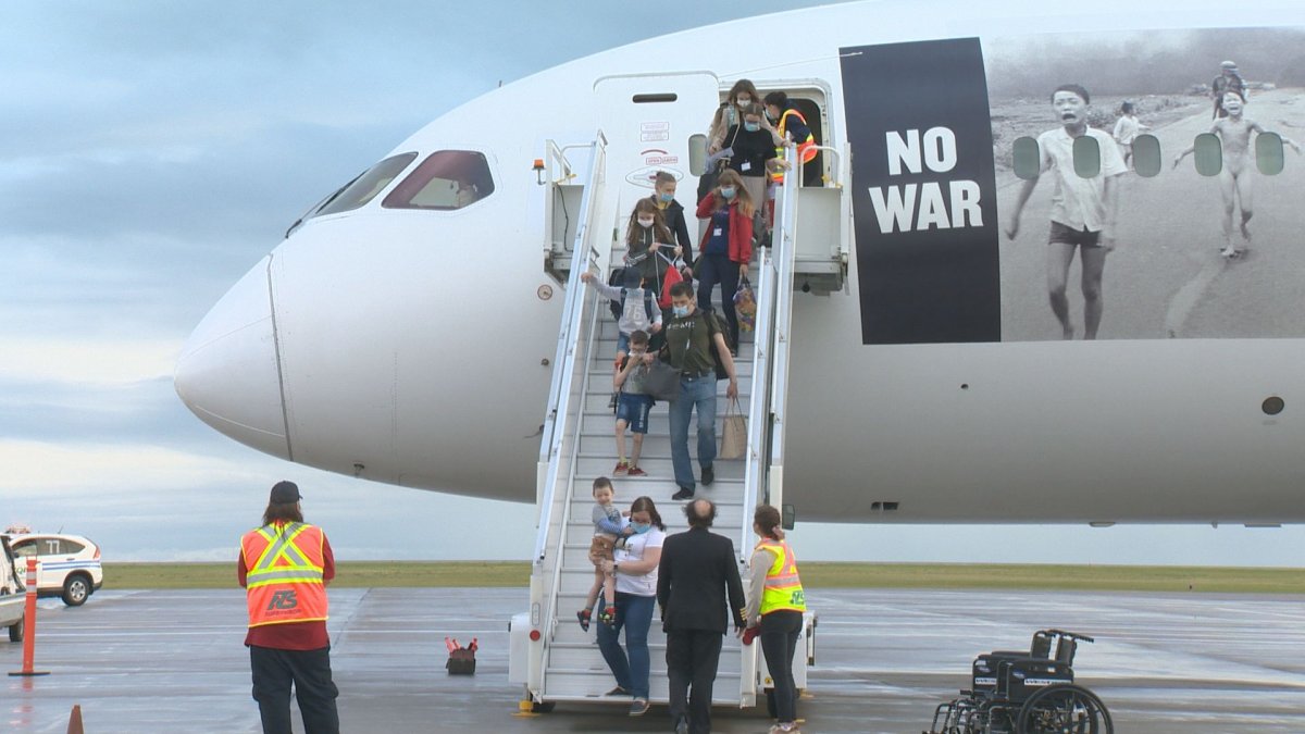 Refugees getting off a plane in Saskatchewan.