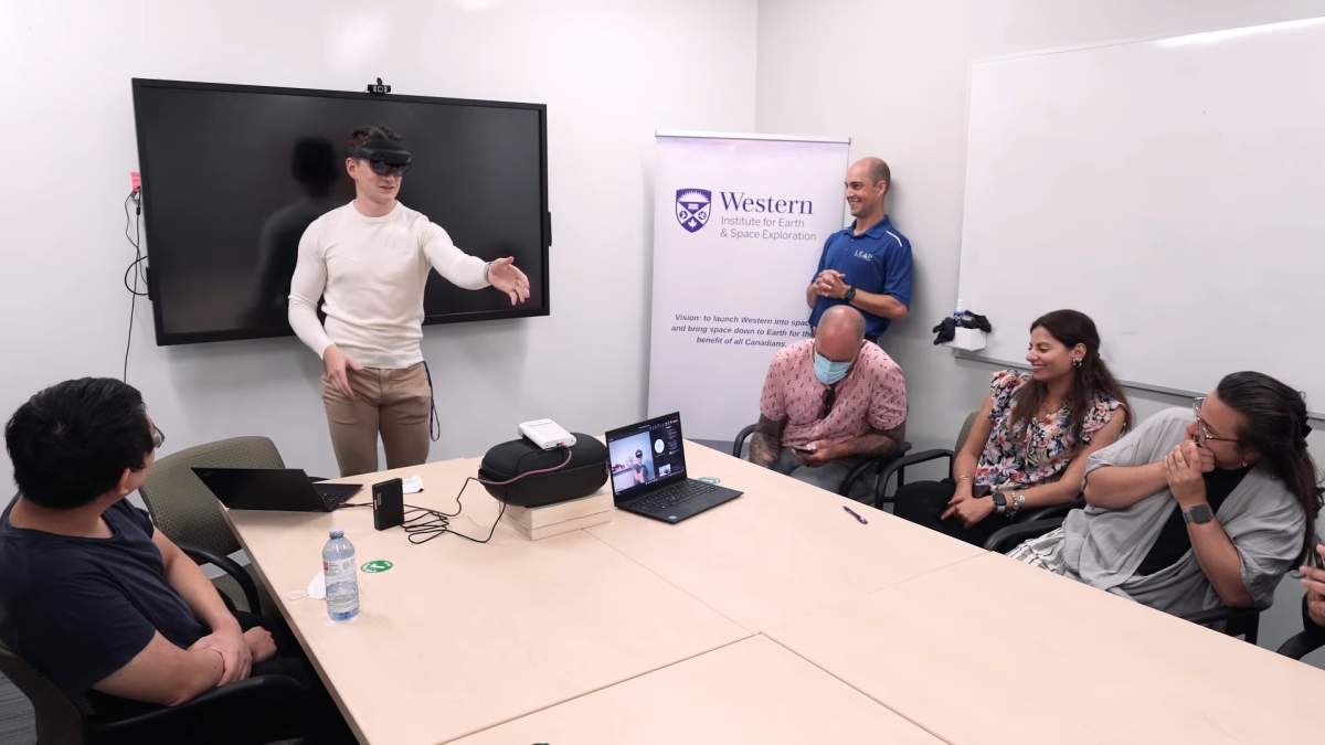 A Western participant wearing a HoloLens attempts to handshake with another HoloLens wearer in Alabama.