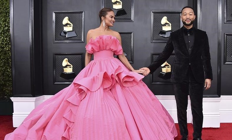 Chrissy Teigen, left, and John Legend arrive at the 64th Annual Grammy Awards at the MGM Grand Garden Arena on April 3, 2022, in Las Vegas.
