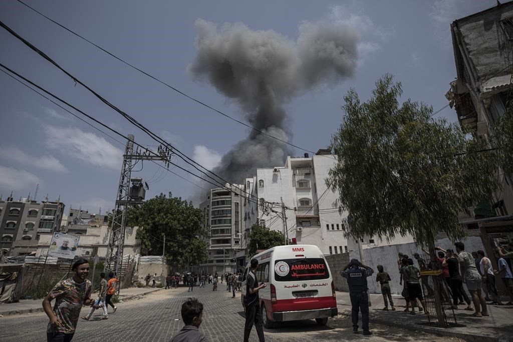 Smoke rises after Israeli airstrikes on residential building, in Gaza City, Saturday, Aug. 6, 2022.