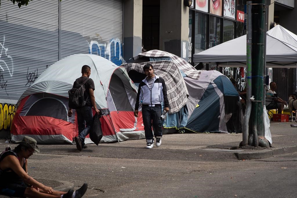 Tents line the sidewalk on East Hastings Street in the Downtown Eastside of Vancouver, where city workers started efforts to clear the encampment on Tuesday, August 9, 2022.