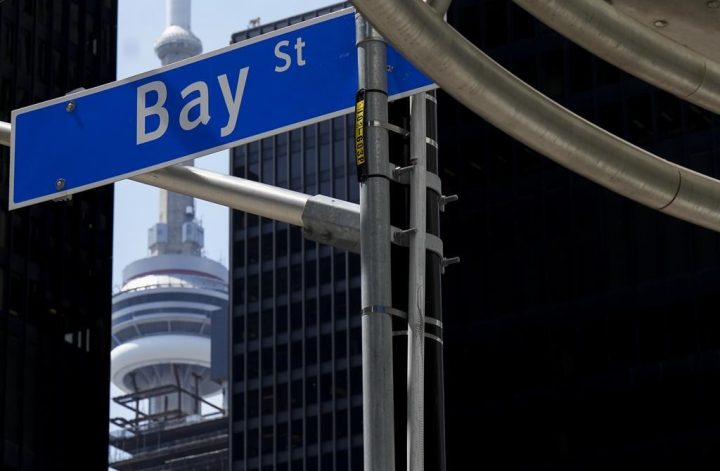 The Bay Street Financial District is shown next to the CN Tower in Toronto on Friday, August 5, 2022. 