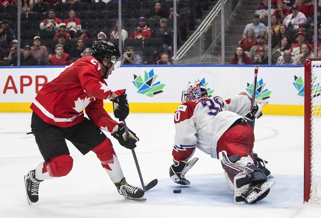 File: Canada's Mason McTavish (23) scores a goal against Czechia's goalie Tomas Suchanek (30) during second period IIHF World Junior Hockey Championship action in Edmonton on Saturday August 13, 2022.