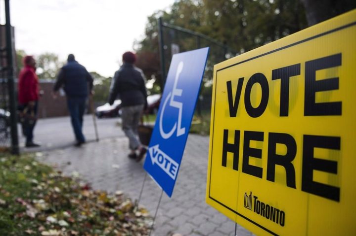 People enter a voting location on municipal election day in Toronto on October 22, 2018. 