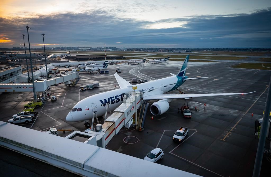A WestJet Airlines Boeing 787-9 Dreamliner is seen parked at a gate at Vancouver International Airport, in Richmond, B.C., on January 21, 2021. WestJet is arguing it shouldn't have to compensate a passenger who filed a complaint with the Canadian Transportation Agency last year about a last-minute flight cancellation prompted by a lack of staff.