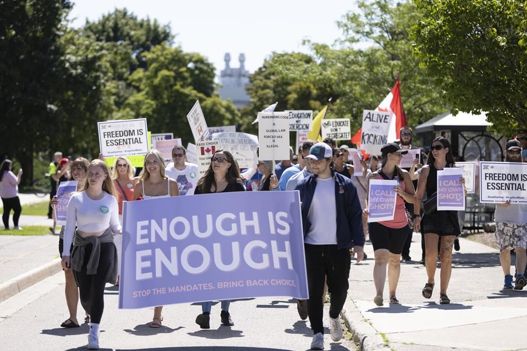 A group of Western University students hold a protest against the school's COVID-19 mandates on Saturday Aug. 27, 2022. The London, Ont., university announced Monday that anyone on campus in the fall must have at least three COVID-19 shots and wear masks in classrooms. THE CANADIAN PRESS/Nicole Osborne.