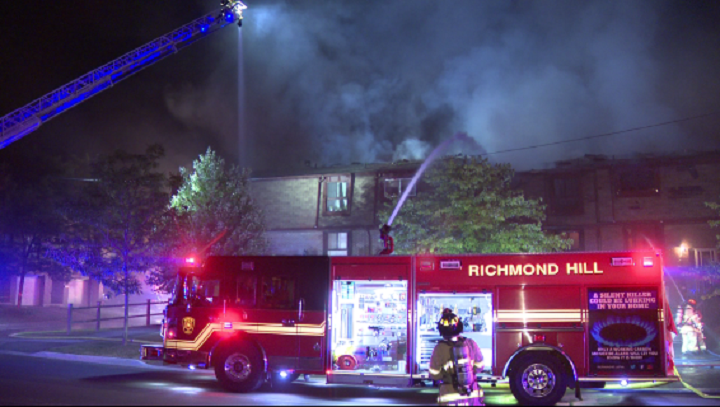 Firefighters battle a blaze around 1 a.m. at a townhouse complex in Richmond Hill.