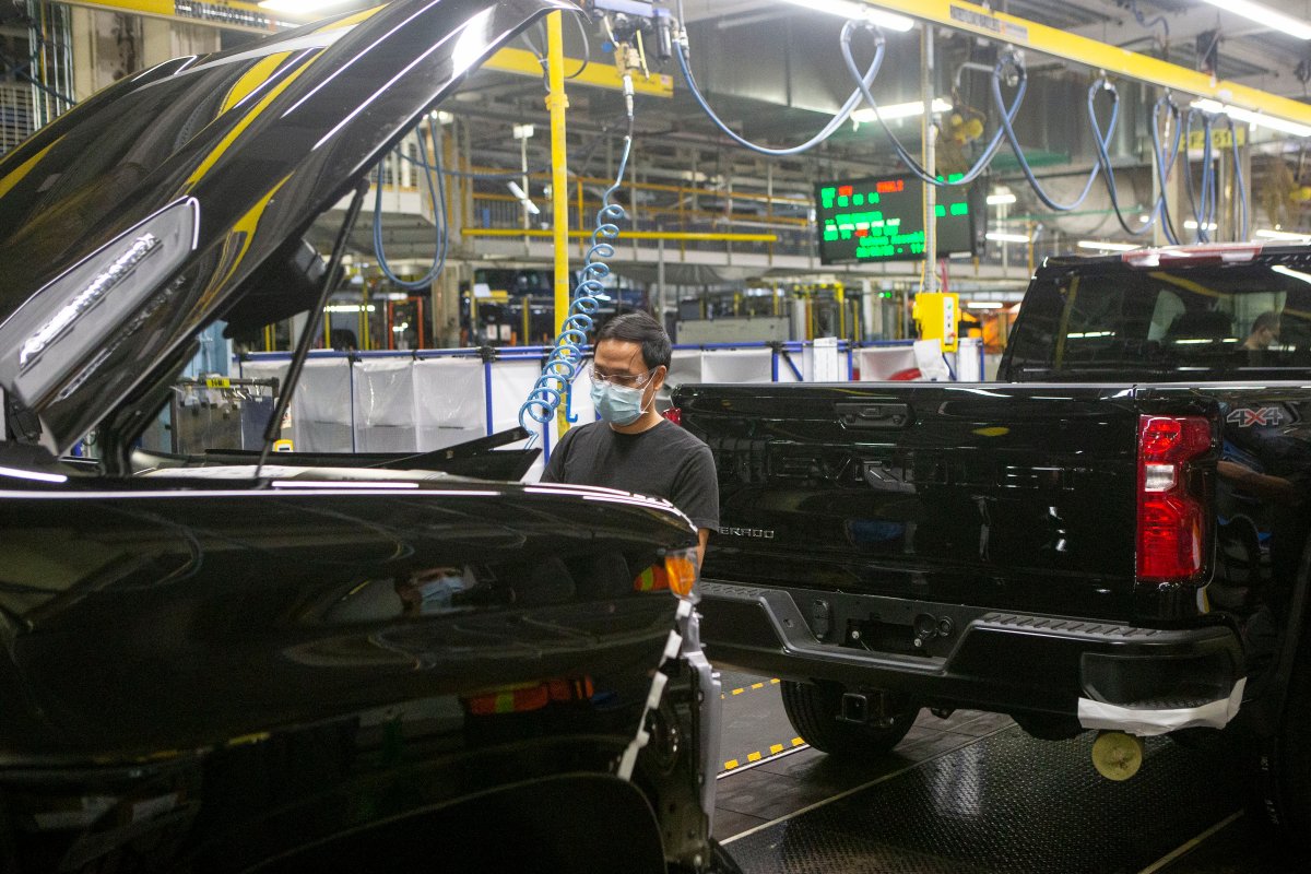 FILE - An auto worker is seen on the General Assembly line  producing the Chevrolet Silverado, at the GM plant in Oshawa, Ontario, on Tuesday, February 22 2022.