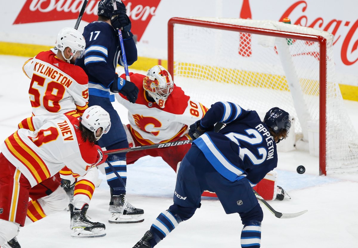 Winnipeg Jets' Mason Appleton (22) scores on Calgary Flames goaltender Dan Vladar (80) during second period NHL action in Winnipeg, Friday, April 29, 2022.