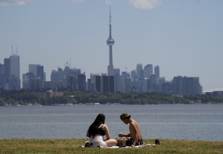 People eat lunch on a hot day in Toronto on Thursday, June 23, 2022. 