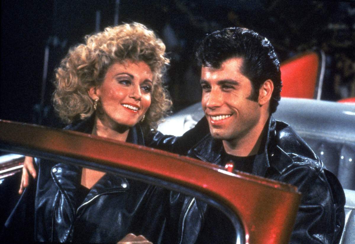 Olivia Newton-John and John Travolta as Sandy and Danny, wearing leather jackets in 'Grease.'