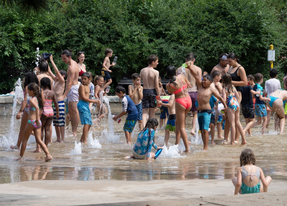 People cool off at a splash pad in Montreal in 2022.