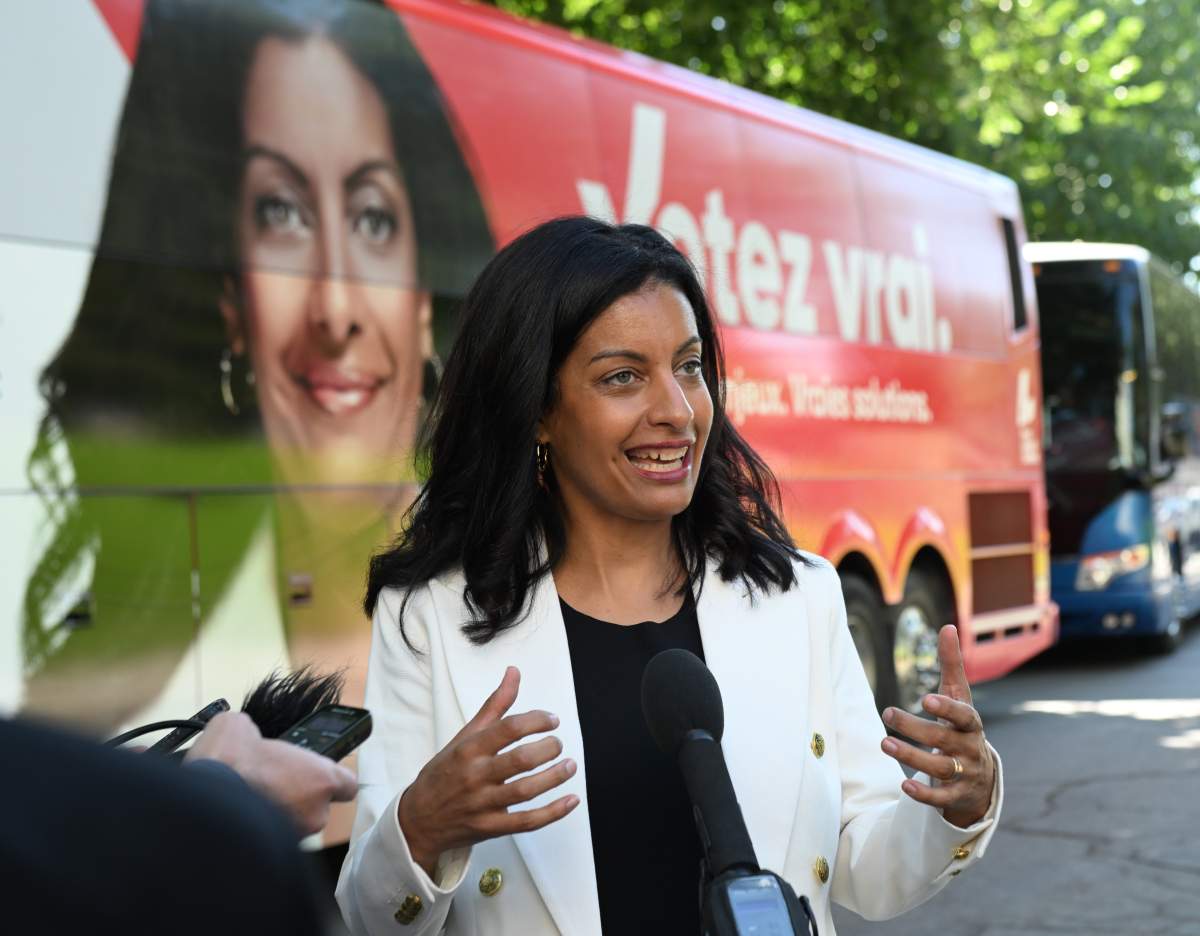 Quebec Liberal Leader Dominique Anglade responds to reporters questions by her campaign bus as she departs for the campaign trail, Sunday, August 28, 2022 in Quebec City. Quebecers are going to the polls for a general election on Oct. 3. THE CANADIAN PRESS/Jacques Boissinot