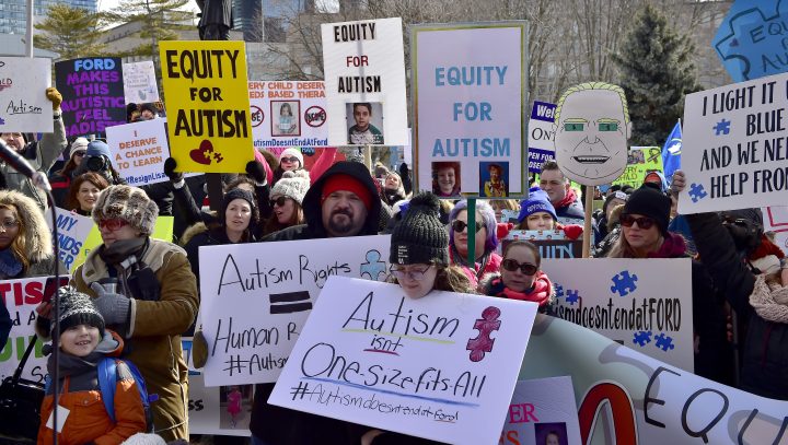 Hundreds of parents, therapists and union members gather outside Queen's Park, in Toronto on Thursday, March 7, 2019, to protest the provincial government's changes to Ontario's autism program.