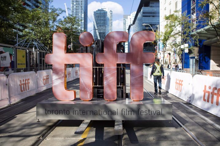 A sign bearing the Toronto International Film Festival logo is carried on a forklift down street in Toronto as preparations are made for the festival's opening night on September 7, 2017.