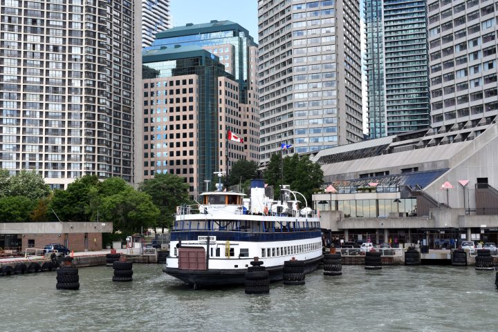 The Toronto Islands ferry Sam McBride sits at dock at the Jack Layton Ferry Terminal beneath the city's office skyline in Toronto, Ontario on July 25, 2022.