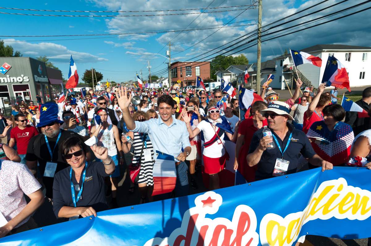Prime Minister Justin Trudeau walks with the crowd during the Tintamarre in celebration of the National Acadian Day and World Acadian Congress in Dieppe, N.B., Thursday, Aug. 15, 2019. THE CANADIAN PRESS/Marc Grandmaison