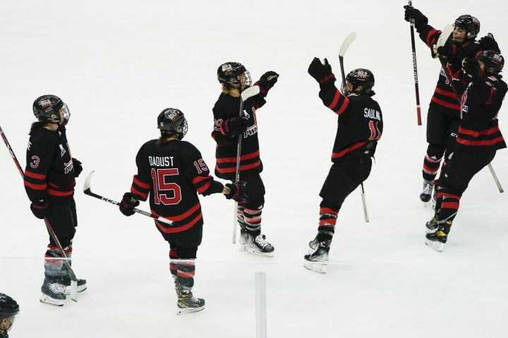 Canada’s Marie-Philip Poulin (29) celebrates with teammates after scoring against the United States during overtime in an exhibition hockey game Saturday, March 12, 2022, in Pittsburgh. Canada won 4-3.
