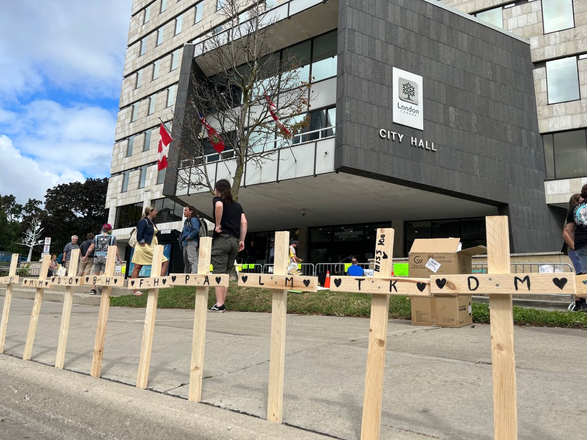 Crosses sit outside London's City Hall on Aug. 2, 2022 as part of a memorial set up by local advocacy group The Forgotten 519 to honour lives lost among those experiencing homelessness.