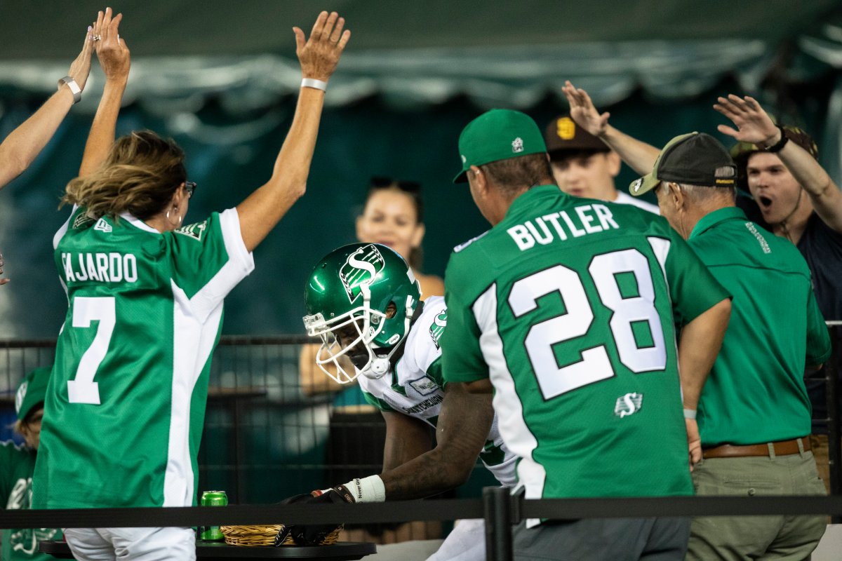 Saskatchewan Roughriders wide receiver D'haquille Williams (5) jumps in with fans after scoring a touchdown on the Edmonton Elks during second half CFL action in Edmonton on Saturday, Aug. 13, 2022.