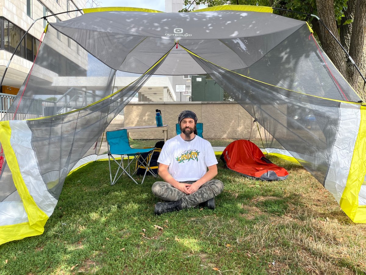Dan Oudshoorn sits inside a tent near City Hall.