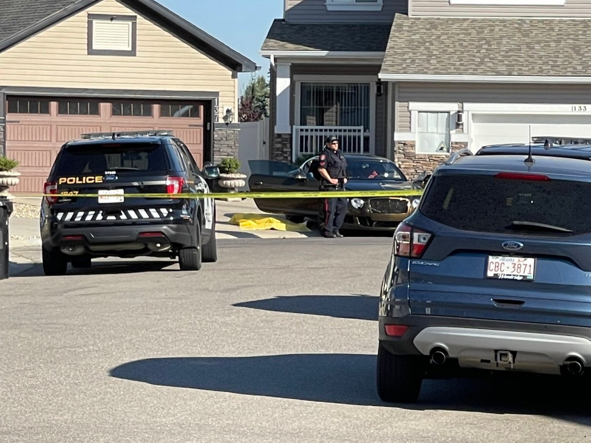 Calgary police block off the 100 block of Everwoods Court S.W.  after a woman died from gunshot wounds and a man was sent to hospital in life-threatening condition on Aug. 18, 2022.