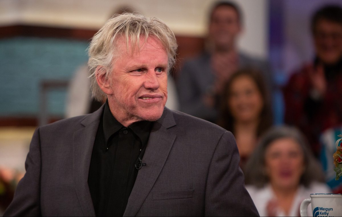 Gary Busey in a black suit.