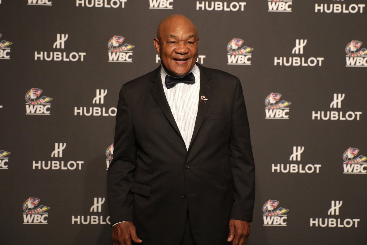 George Foreman in a suit and bowtie on a red carpet.