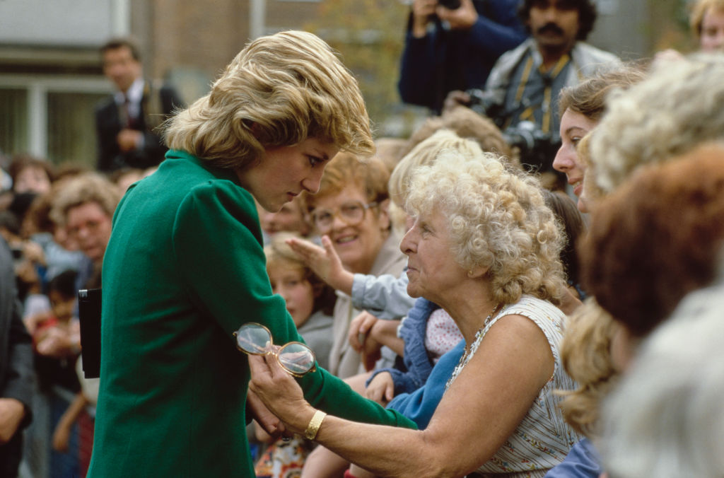 Princess Diana, wearing a green coat, interacts with crowd at St Joseph's Hospice in Hackney, London, England, in 1985.