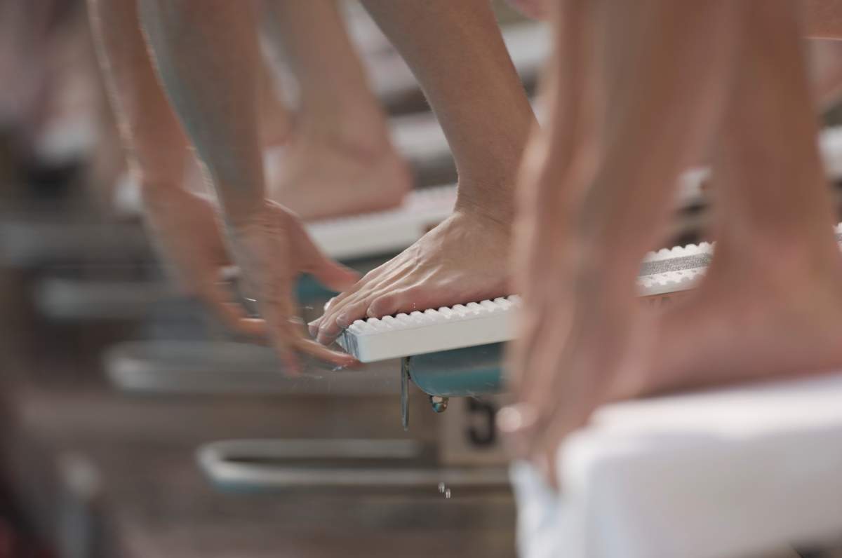 A file photo of swimmers on starting blocks before a race.