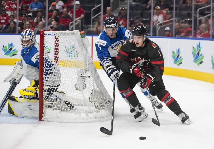 Canada’s Ridly Greig (17) and Finland’s Joni Jurmo (4) battle for the puck as goalie Leevi Merilainen (1) looks for the puck during second period IIHF World Junior Hockey Championship action in Edmonton on Monday August 15, 2022.