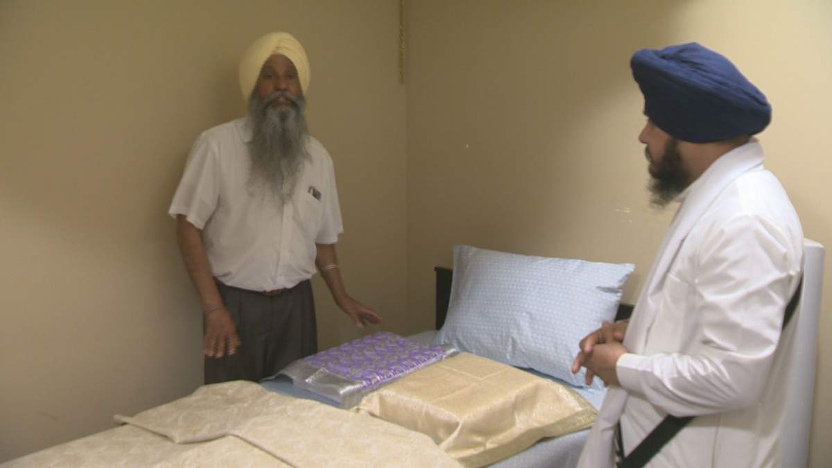Bill Singh (left) Sikh Society of Regina President and priest at Gurudwara located at 3905 Princess Drive. Showing where they keep holy books that are old and or need fixing.
