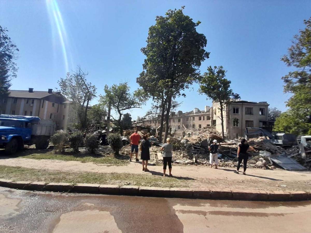 Residents observe a destroyed building in Kharkiv, Ukraine, during the Ukraine-Russia war.