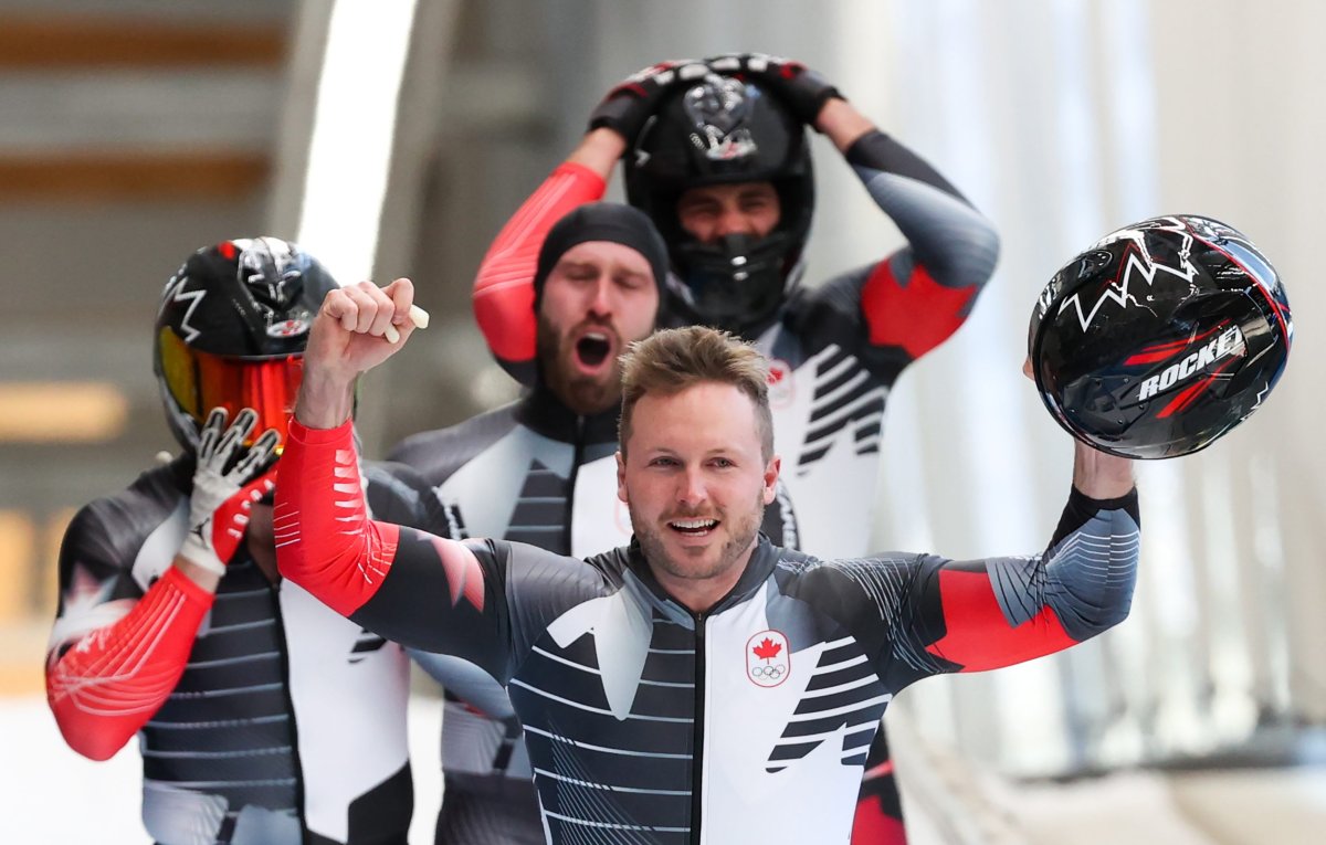 Justin Kripps, front, plus Ryan Sommer, Cam Stones, and Benjamin Coakwell of Canada celebrate after finishing a run during the 2022 Winter Olympic Games.