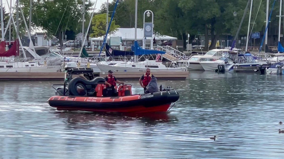 The Canadian Coast Guard carries a woman back into the Cobourg Harbour after she drifted into Lake Ontario on an inflatable inner tube.