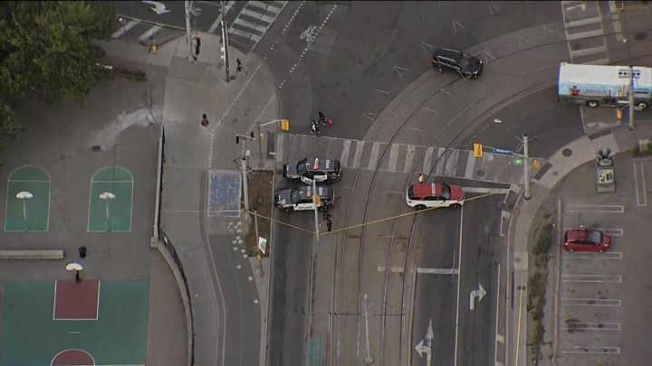 Police are seen blocking a portion of Queens Quay West after a stabbing.