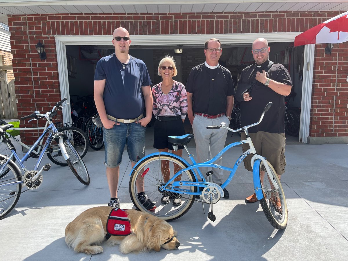 From left to right: AJ McCallum, Heather McCallum, John Maroney and Kevin George stand in front of one of more than 80 bikes the group helped collect this month for migrant workers in the region.